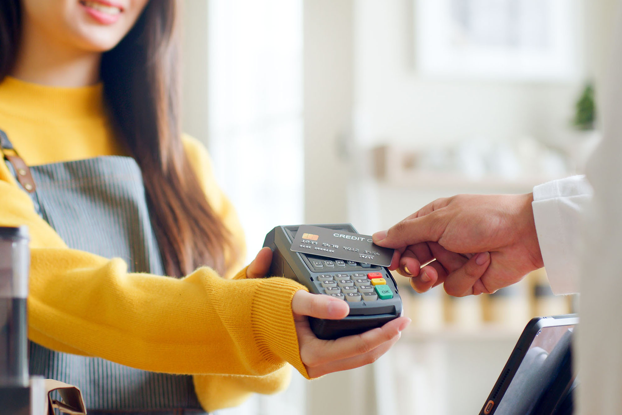 woman taking payment with first federal credit card